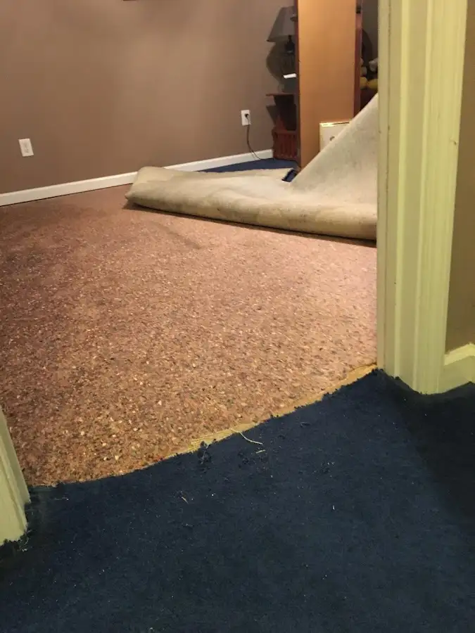 Carpet pad removal revealing water damage during Water Mitigation Services in Sumpter
