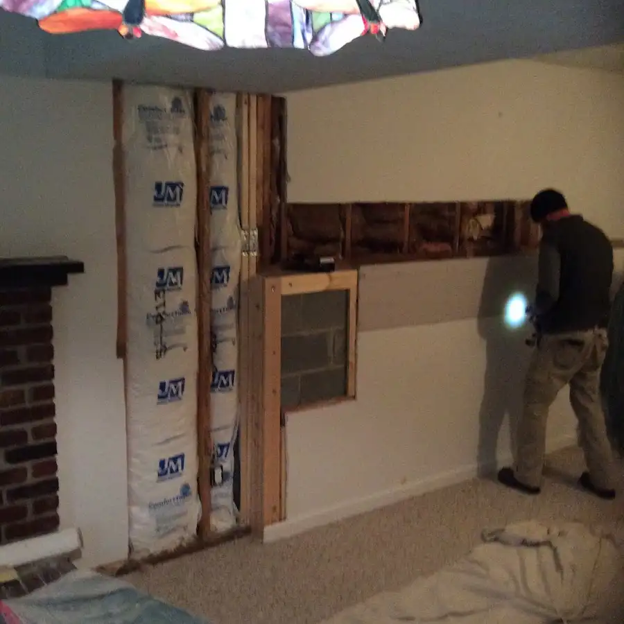 Restoration technician inspecting water damage in Sumpter